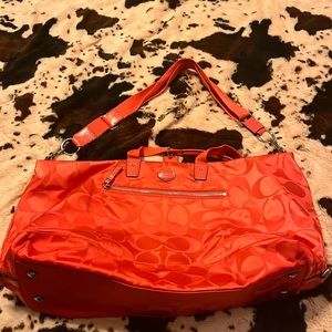 Neon Orange Coach duffel bag w/ detachable strap and zipper close
